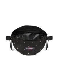 Czarna saszetka w srebrne groszki, z zamkiem błyskawicznym i wewnętrzną podszewką. Posiada regulowany sznurek oraz naszywkę z logo Eastpak na przedniej stronie.