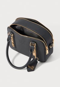 Black Love Moschino handbag with gold zippers, two handles, and branded gold charm tags on a plain white background.