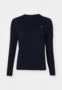Maglione a maglia blu navy con scollatura rotonda, maniche lunghe e orlo a coste. Presenta un piccolo logo ricamato sul petto.