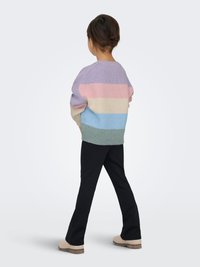 Knit sweater featuring horizontal stripes in lavender, pink, cream, and light blue; paired with black flared pants and beige shoes.