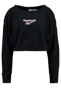 Sudadera negra recortada con mangas largas, que presenta un logo de Reebok en blanco y morado en la parte delantera. Textura suave, escote ancho tipo barco.