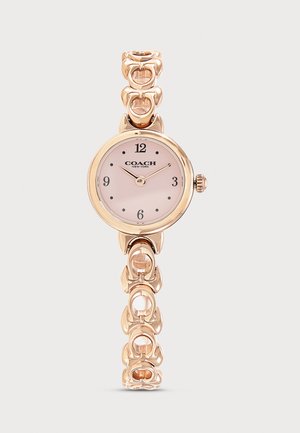 Montre-bracelet Coach ton or avec un cadran rond rose, chiffres noirs et un bracelet à maillons décoratif.