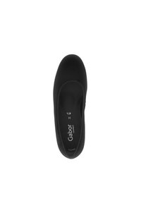 Black flat shoe with a smooth, soft material. Rounded toe and cushioned insole. Features brand name "Gabor" and size details inside.