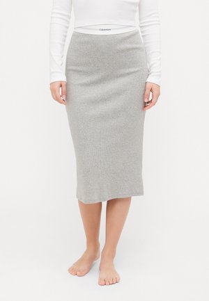 Gray knit skirt with a fitted silhouette, mid-calf length, and a snug waistband featuring the Calvin Klein logo. Soft texture, simple design.
