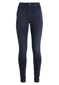 Tummansiniset kapeat farkut joustavasta denimmateriaalista, joissa viisi taskua, korkea vyötärö ja sileä pinta, jossa on vain vähän haalistumia.