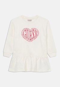 Robe blanche à manches longues avec un bas évasé. Pr�ésente un design de cœur en texte graphique rose centré sur la poitrine. Matériel en coton doux.