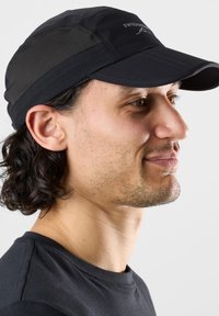 Black athletic cap with a curved visor and mesh side panels. Features a subtle logo on the front, made of lightweight, breathable material.