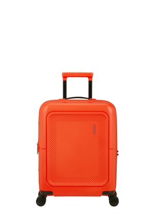 Bright orange hard-shell suitcase with four black spinner wheels and extended telescopic handle, standing upright on white background.