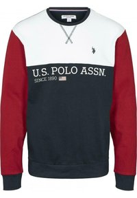 Marinblå och röd sweatshirt med vit övre del. Har text och logotyp från U.S. Polo Assn. samt rundad halsringning. Mjuk, strukturerad tyg.