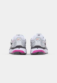 Gray and white sneakers with pink accents, mesh upper, cushioned sole, and reflective details, designed for comfort and stability.