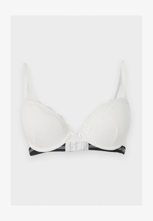 Λευκό μαξιλαρωμένο σουτιέν με δαντελένιο τελείωμα, ρυθμιζόμενες τιράντες και μαύρη ελαστική ταινία κάτω με λευκές λεπτομέρειες κειμένου.
