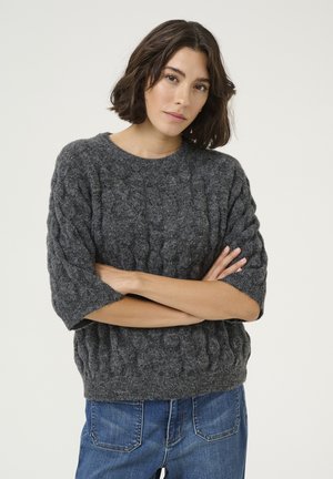 Gray knitted sweater with a textured cable pattern, short sleeves, and a round neckline, paired with blue denim jeans.