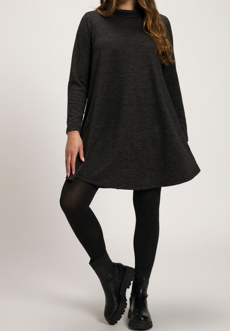 Dark grey, long-sleeve dress with a relaxed fit and rounded neckline, paired with black leggings and sturdy ankle boots. Smooth texture.