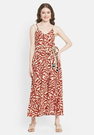 Maxi dress in red and cream with abstract patterns, thin straps, ruffled accents, and a tied waist belt. Smooth texture, lightweight fabric.