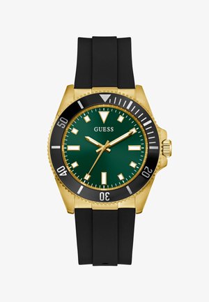 Gull og svart Guess klokke med grønn urskive, svart bezel, gull time markører, og svart silikonrem, viser 2:08:36.