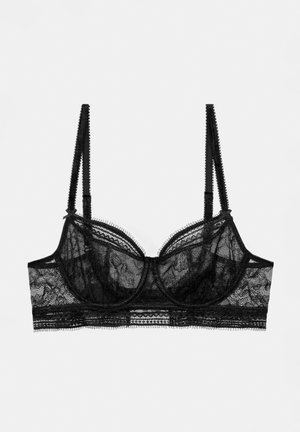 Soutien-gorge en dentelle noire avec armatures, bonnets transparents et bretelles réglables. Des finitions délicates et des bords en forme de vagues rehaussent le design.