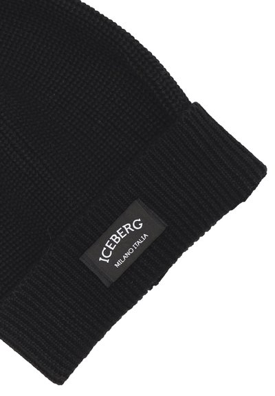 Beanie nero lavorato a maglia con texture a costine, dotato di un'etichetta tessuta rettangolare che riporta la scritta "ICEBERG MILANO ITALIA."