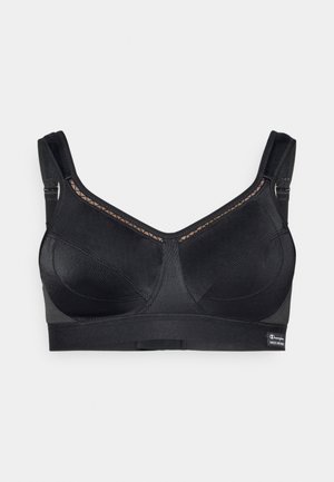 Brassière de sport noire avec un design texturé, des bretelles réglables et une fermeture à agrafes. Panneau en mesh pour plus de ventilation et de détails.