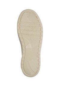 Sole of a shoe featuring a textured, light beige rubber material with curved and linear patterns for traction. Rounded toe and heel areas.