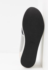 Gray textile sneaker with a black rubber sole. Features a soft texture and a contrasting light stripe along the edge. Marked with "s.Oliver 37."