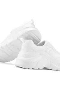 White sneaker featuring a textured design, padded collar, and thick, rubber outsole. The material appears synthetic with minimal accents.