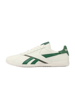 White Reebok low-top sneaker with green stripes and heel tab, textured sole, and laces, shown in side profile facing right.