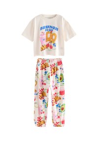 Kremowy t-shirt z krótkim rękawem z grafiką "BRUNCH CLUB", zestawiony z spodniami na elastycznym pasku w kolorowe wzory tematycznie związane z jedzeniem.