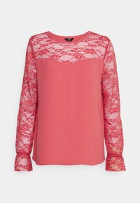 Langarmtop met een roze lichaam en delicate kanten mouwen. Ronde halslijn, gladde textuur en uitlopende manchetten met kantafwerking.