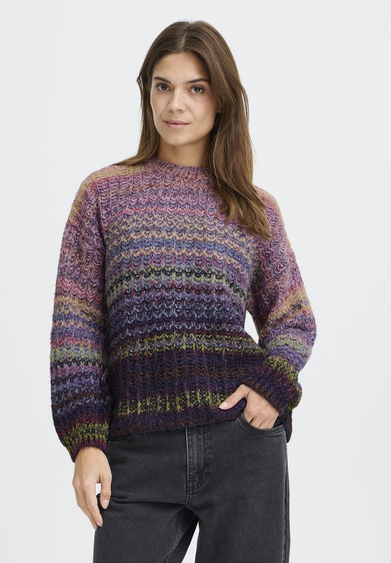 Kootud sviiter, millel on mitmevärvilised horisontaalsed triibud lilla, rohelise ja roosa tooni; ümmargune kaelus, laiad varrukad ja tekstureeritud lõng.