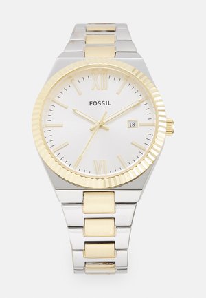Silver and gold metal watch with a white dial, Roman numeral markers, date display, and a ridged gold bezel. Stainless steel bracelet style.