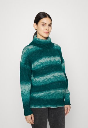 Pull rayé vert et bleu canard avec un col montant, texture tricotée et coupe ample. Présente des manches longues et effilées ainsi qu'une silhouette décontractée.