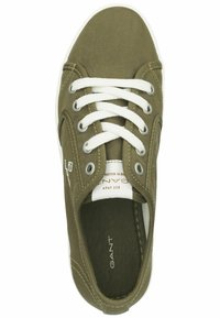Olive green canvas sneaker with white laces, round toe, and rubber sole; features stitched accents and branding on the insole.
