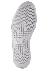 White rubber sneaker sole with herringbone pattern, textured grip areas, rounded heel, and DC logo centrally positioned.