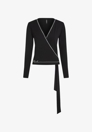 Črna oprijeta zgornja majica z dolgimi rokavi, okrašena z belim obrobjem ob izrezu in robu, z detajlom zavezovanja na strani in rebrasto teksturo.