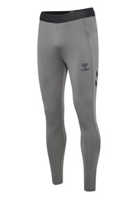 Leggings de sport gris avec une coupe ajustée, taille noire, panneaux latéraux texturés et un logo discret près du genou.