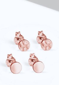 Cercei cu tija din aur roz, având un design circular texturat și o finisare netedă și oglindită, cu un sistem de prindere sigur cu tija în spate.