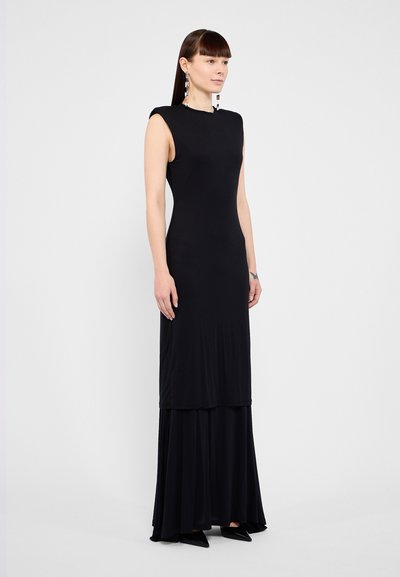 Black sleeveless dress with a fitted bodice and a flowy, tiered skirt. Made of smooth fabric, it features a minimalistic design and no visible patterns.