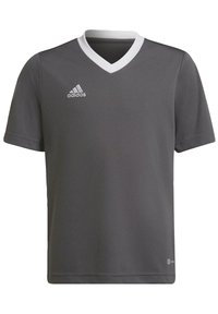 Szary koszulka piłkarska z krótkim rękawem i białym dekoltem w kształcie litery V, z haftowanym białym logo na piersi i gładką fakturą tkaniny.