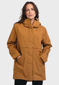 Braune, kapuzenförmige, wasserdichte Jacke aus synthetischem Material mit Druckknopfverschlüssen, zwei Seitentaschen und einem dezenten Logo auf der Brust.