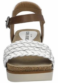 White woven leather sandal with brown ankle strap, cushioned cork footbed, and white platform sole. Flat, wide straps provide support.