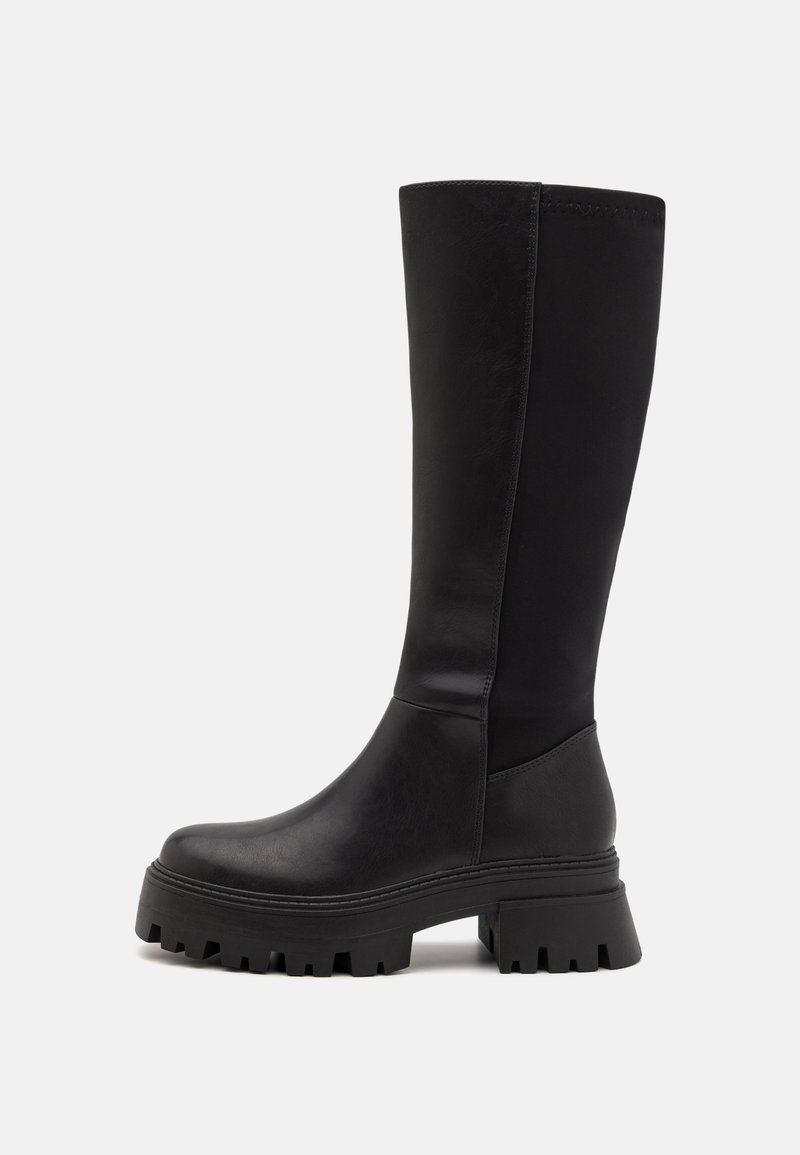 Black knee-high boots made of smooth leather, featuring a chunky rubber sole and a sleek design with minimal stitching and elastic panels.