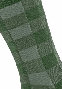 Calzini verdi con un motivo a scacchi in diverse tonalità di verde, realizzati in tessuto testurizzato, che evidenziano un design a metà polpaccio.