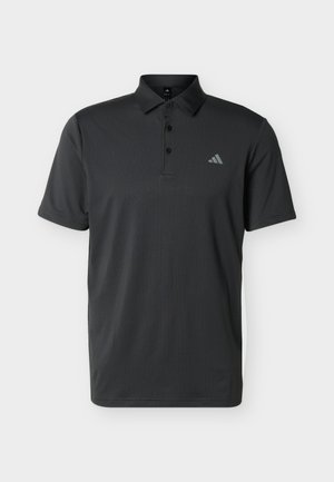 Must lühikeste varrukatega polo särk, millel on kolme nupuga plastron ja väike Adidas logo vasakul rinnal, tekstureeritud kangas.