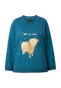 Felpa teal con maniche lunghe, caratterizzata da una grafica di una mucca Highland e la scritta "let it snow". Tessuto morbido con una vestibilità relaxed.