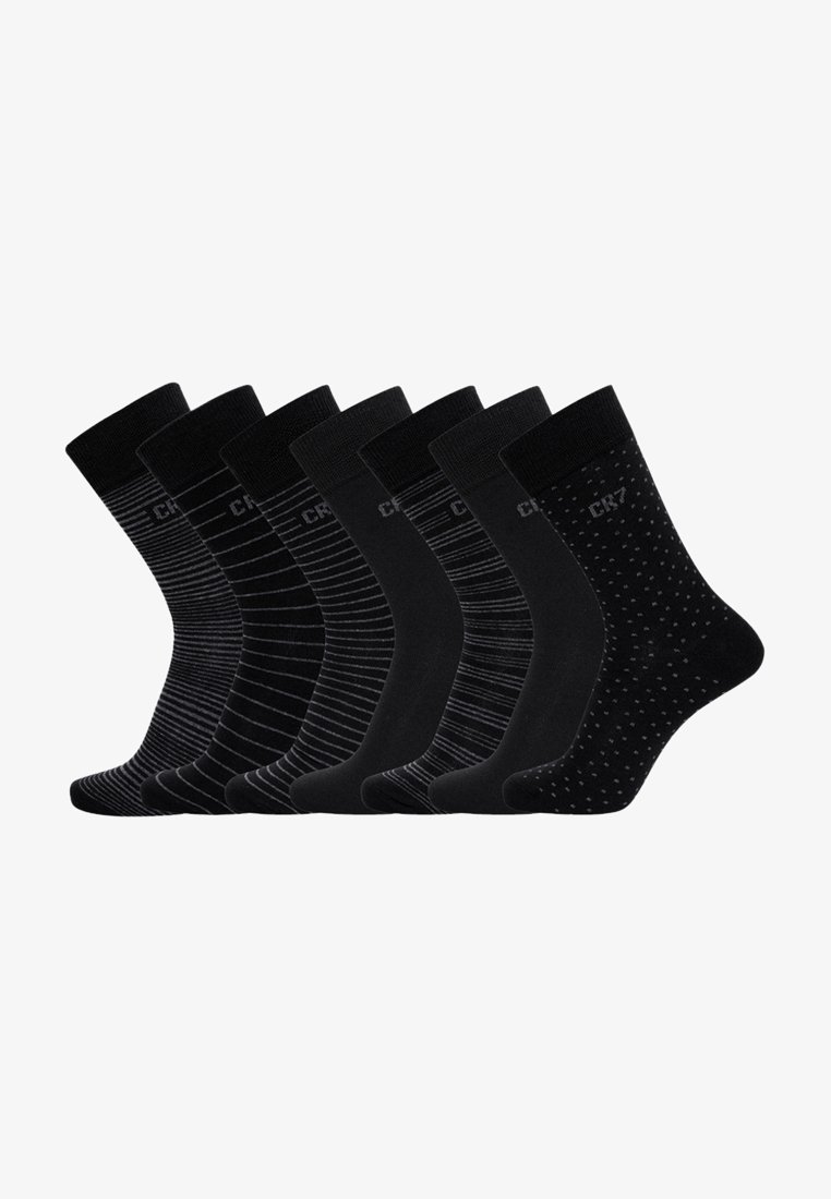 Set aus sieben schwarzen Socken mit verschiedenen Mustern: feine Streifen, einfarbig und gepunktet. Aus weichem Stoff hergestellt; mittellange Knöchelhöhe.