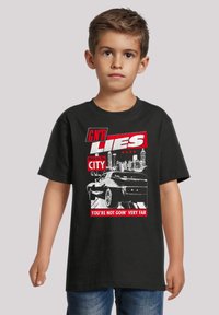 Black cotton t-shirt featuring a graphic print of a car and text in red and white that reads "GN'R LIES" and "YOU'RE NOT GOIN' VERY FAR."