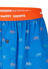 Short bleu avec des motifs de bicyclettes multicolores et une ceinture orange présentant le texte blanc "HAPPY SHORTS."