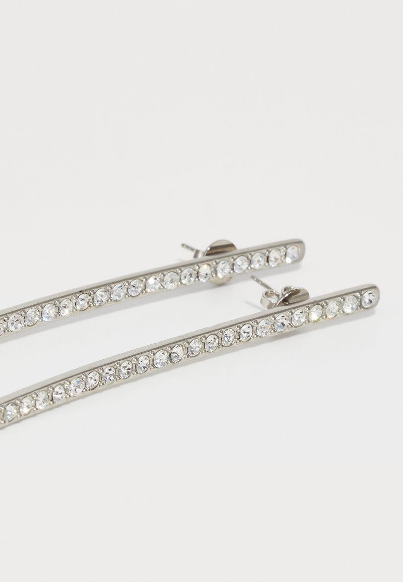 Silver-tone earrings with a slim bar design, featuring a row of clear, round crystals along the length. Secure post back closure.