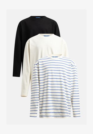 T-shirt a maniche lunghe in nero, crema e bianco con strisce blu. Tessuto in cotone morbido; scollature rotonde; vestibilità rilassata; branding minimale.