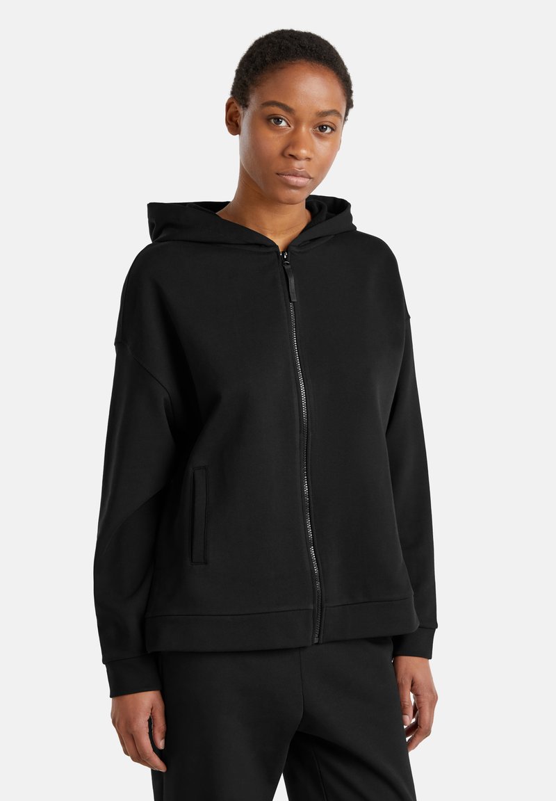 Felpa nera con zip realizzata in tessuto morbido, con cappuccio, tasche frontali e vestibilità comoda, con polsini e orlo a coste. Design semplice.